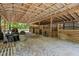 Interior view of a barn with wooden stalls and ample space at 5363 Utopia Pl, Brooksville, FL 34601