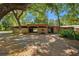 Rustic barn with a wooden facade surrounded by lush green foliage at 5363 Utopia Pl, Brooksville, FL 34601