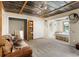 Basement area featuring a bed, couch, and rustic decor, providing a relaxed space at 5363 Utopia Pl, Brooksville, FL 34601