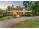 Charming two-story home featuring a spacious covered porch and a serene wooded setting at 5363 Utopia Pl, Brooksville, FL 34601