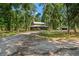 Lovely home exterior with a charming covered porch and a picturesque, tree-filled yard at 5363 Utopia Pl, Brooksville, FL 34601