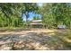 Exterior view of a home and property, surrounded by tall trees at 5363 Utopia Pl, Brooksville, FL 34601