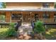 Inviting front porch with wooden steps, decorative planters, and a cozy seating area for relaxing and enjoying the outdoors at 5363 Utopia Pl, Brooksville, FL 34601
