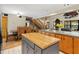Open kitchen with wooden cabinets, contrasting island, and dining area access at 5363 Utopia Pl, Brooksville, FL 34601