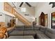 Living room with a staircase, high ceilings, and a large sectional sofa at 5363 Utopia Pl, Brooksville, FL 34601
