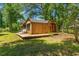 Charming outbuilding with a deck, surrounded by mature trees and landscaping at 5363 Utopia Pl, Brooksville, FL 34601