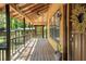Long wooden porch with railing, decorative wreaths, and views of the surrounding landscape offering a peaceful outdoor space at 5363 Utopia Pl, Brooksville, FL 34601