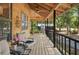Covered porch with a chair, table, and views of the yard offering a relaxing space for outdoor enjoyment at 5363 Utopia Pl, Brooksville, FL 34601
