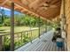 Spacious porch overlooking a lush, green field with a convenient generator and storage, enhancing outdoor living at 5363 Utopia Pl, Brooksville, FL 34601