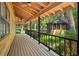 Long porch with wooden ceiling and railings overlooking the lush, green yard providing a tranquil outdoor retreat at 5363 Utopia Pl, Brooksville, FL 34601
