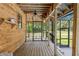 Spacious screened porch with wood flooring, ceiling fan, and views of the surrounding landscape at 5363 Utopia Pl, Brooksville, FL 34601