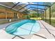 Beautiful pool with steps, surrounded by a screened enclosure, perfect for swimming and relaxation at 5363 Utopia Pl, Brooksville, FL 34601