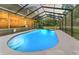 Backyard pool with screened-in enclosure, lights and lounge chairs offers a private, relaxing space at 5363 Utopia Pl, Brooksville, FL 34601
