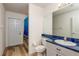 Bathroom with blue countertop, toilet, and shower with a fish-themed curtain at 5423 Abagail Dr, Spring Hill, FL 34608