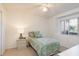 Cozy bedroom with a twin bed, a ceiling fan, and natural light from a window at 5423 Abagail Dr, Spring Hill, FL 34608