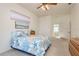 Bedroom has coastal-themed decor, a window with blinds, and access to the rest of the home at 5423 Abagail Dr, Spring Hill, FL 34608