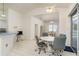 Bright dining area features pool view through sliding glass doors and access to the kitchen with a breakfast bar at 5423 Abagail Dr, Spring Hill, FL 34608