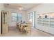 Bright dining room with direct pool view through sliding glass doors, a decorative hutch, and built-in cabinets at 5423 Abagail Dr, Spring Hill, FL 34608