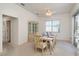 Dining room with a glass cabinet and a table set for six, with a sliding glass door to the pool area at 5423 Abagail Dr, Spring Hill, FL 34608