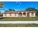 Charming home featuring a well-manicured lawn and inviting front entrance with stylish architectural details at 5423 Abagail Dr, Spring Hill, FL 34608