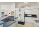 This kitchen has white appliances and cabinets, blue countertops, and two pendant lights over the sink at 5423 Abagail Dr, Spring Hill, FL 34608
