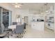 Open kitchen and dining area with tile flooring, white cabinetry, and a breakfast bar at 5423 Abagail Dr, Spring Hill, FL 34608