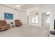 Open living area with neutral carpet, access to the foyer, and comfortable seating at 5423 Abagail Dr, Spring Hill, FL 34608