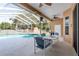 Cozy outdoor dining area with a screened-in pool view and a ceiling fan at 5423 Abagail Dr, Spring Hill, FL 34608