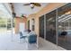 Screened patio with comfortable seating, ceiling fans, and a view of the pool area, ideal for relaxation at 5423 Abagail Dr, Spring Hill, FL 34608
