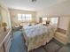 Bedroom with large bed, bedside tables, and a comfortable seating area by the window at 5627 Ferguson Ct # 1303, New Port Richey, FL 34652