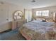 Bedroom showcasing a bed, dresser with mirror, and window allowing natural light at 5627 Ferguson Ct # 1303, New Port Richey, FL 34652
