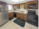 Functional kitchen with stainless steel refrigerator, black appliances, and ample cabinet space at 5627 Ferguson Ct # 1303, New Port Richey, FL 34652