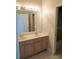 Bathroom with double sink vanity and a large mirror, offering functionality and style at 5701 Brackenwood Dr, Spring Hill, FL 34609