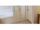 Bathroom featuring a shower stall, a garden tub, neutral tile flooring, and a white door at 5701 Brackenwood Dr, Spring Hill, FL 34609