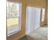 Bright bedroom featuring a window with blinds, and light tan carpet at 5701 Brackenwood Dr, Spring Hill, FL 34609