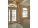 Entrance foyer with tile flooring and double front doors, complemented by large windows for natural light at 5701 Brackenwood Dr, Spring Hill, FL 34609