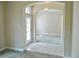 Inviting foyer with tile flooring transitions to a carpeted living space, complemented by an elegant chandelier at 5701 Brackenwood Dr, Spring Hill, FL 34609