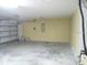 Spacious two car garage with a white door at 5701 Brackenwood Dr, Spring Hill, FL 34609