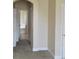 Hallway featuring arched doorways and a view of the front entry door at 5701 Brackenwood Dr, Spring Hill, FL 34609
