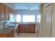 Functional kitchen with granite countertops, wooden cabinets, and a refrigerator at 5701 Brackenwood Dr, Spring Hill, FL 34609