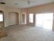 Spacious living room with carpet floors, arched doorways, and natural light at 5701 Brackenwood Dr, Spring Hill, FL 34609