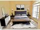 Comfortable main bedroom featuring a decorative rug, a queen bed with neutral bedding, and a sunlit window at 5701 Brackenwood Dr, Spring Hill, FL 34609
