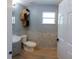 Well-lit bathroom featuring a modern vanity, toilet, and unique decorative shelving at 6172 Raleigh St, Spring Hill, FL 34606