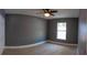 Serene bedroom featuring neutral color scheme, ceramic tile floors, natural light, and fan at 6172 Raleigh St, Spring Hill, FL 34606