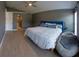 Large primary bedroom with gray walls, wood flooring, and a seating area at 6172 Raleigh St, Spring Hill, FL 34606