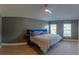 Spacious bedroom with neutral walls, wood-look tile floors, and natural light from multiple windows at 6172 Raleigh St, Spring Hill, FL 34606