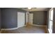 Spacious bedroom with neutral walls, wood-look tile floors, and a double door closet for ample storage at 6172 Raleigh St, Spring Hill, FL 34606
