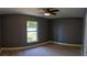 Relaxing bedroom features gray walls, ceramic tile floors, and a window with backyard views at 6172 Raleigh St, Spring Hill, FL 34606