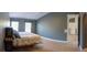 Spacious bedroom with neutral walls, wood-look tile floors, and natural light from multiple windows at 6172 Raleigh St, Spring Hill, FL 34606