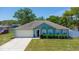 Charming single-story home featuring a well-maintained lawn, attached garage, and a welcoming entryway at 6172 Raleigh St, Spring Hill, FL 34606